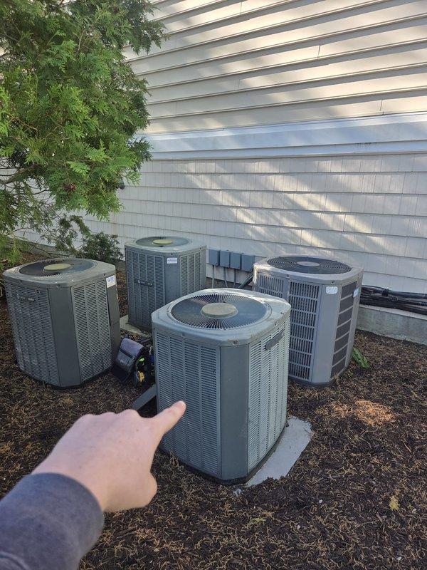 Completed scheduled cooling maintenance visit on multi-unit HVAC system consisting of five outdoor condensing units. Performed comprehensive inspection of all units, verified operational status, and recorded temperature readings. Measured supply line temperature at 51°F on refrigerant lines, indicating proper system performance. All condensing units found operating within normal parameters with adequate airflow through top-mounted fan grilles. Equipment positioned on stable concrete pads with proper clearances maintained for service access and ventilation.