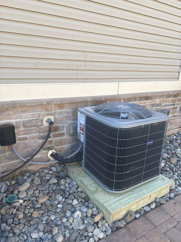 Removed and disposed of existing outdoor air conditioning unit and indoor evaporator coil. Installed new 26SCA536 3-ton air conditioner on exterior wooden platform with proper elevation and rock bed ground cover. Mounted unit against building exterior with electrical whip and disconnect box, securing all conduit along brick facade. Installed CAAMP3617 evaporator coil inside residential HVAC system, integrating with existing furnace, ductwork, dampers, and thermostats. Flushed refrigeration lines, performed pressure test to verify system integrity, and recharged system to manufacturer specifications. Verified all electrical connections, tested system operation, and confirmed proper airflow through existing duct system.