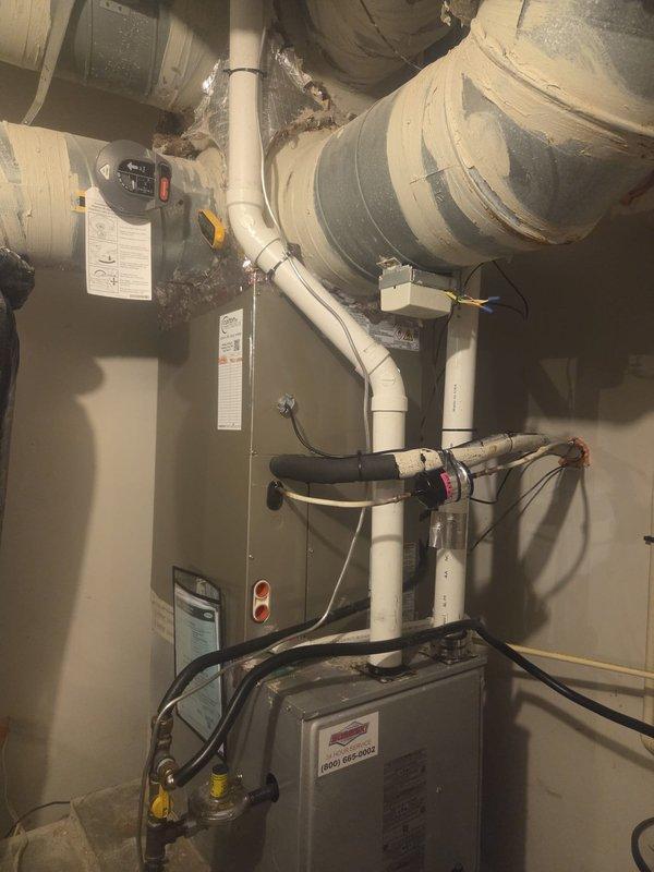 Removed and disposed of existing outdoor air conditioning unit and indoor evaporator coil. Installed new 26SCA536 3-ton air conditioner on exterior wooden platform with proper elevation and rock bed ground cover. Mounted unit against building exterior with electrical whip and disconnect box, securing all conduit along brick facade. Installed CAAMP3617 evaporator coil inside residential HVAC system, integrating with existing furnace, ductwork, dampers, and thermostats. Flushed refrigeration lines, performed pressure test to verify system integrity, and recharged system to manufacturer specifications. Verified all electrical connections, tested system operation, and confirmed proper airflow through existing duct system.