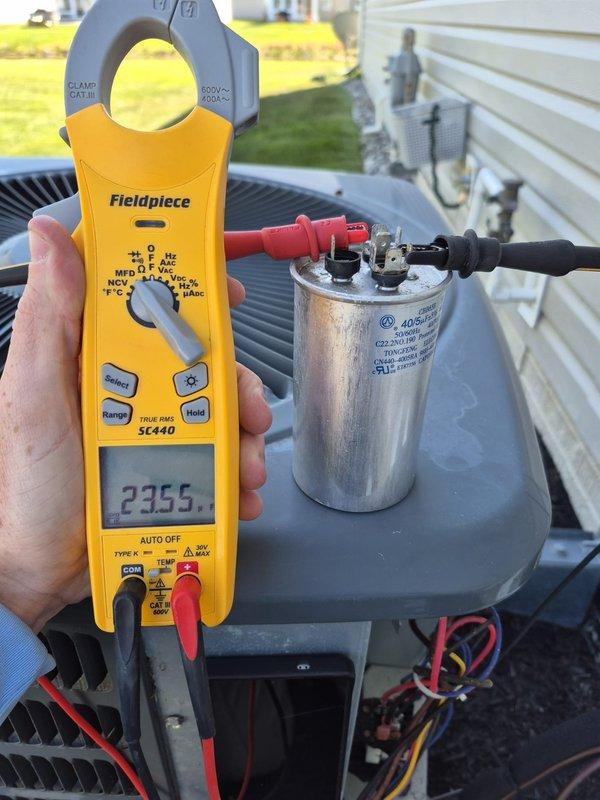 Completed scheduled cooling maintenance visit on residential HVAC system. Performed comprehensive system inspection including electrical diagnostics with clamp meter, verified capacitor functionality and connections, and confirmed proper amperage readings at 23.55 amps. Inspected condenser unit components including coil condition and verified thermostat operations on both Honeywell Home ProSeries and Aprilaire units, which were displaying proper temperature readings and functioning in auto fan mode. All system components operating within normal parameters with no deficiencies noted.