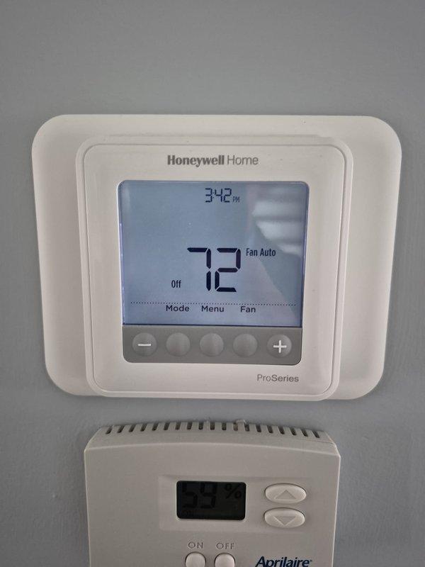 Completed scheduled cooling maintenance visit on residential HVAC system. Performed comprehensive system inspection including electrical diagnostics with clamp meter, verified capacitor functionality and connections, and confirmed proper amperage readings at 23.55 amps. Inspected condenser unit components including coil condition and verified thermostat operations on both Honeywell Home ProSeries and Aprilaire units, which were displaying proper temperature readings and functioning in auto fan mode. All system components operating within normal parameters with no deficiencies noted.