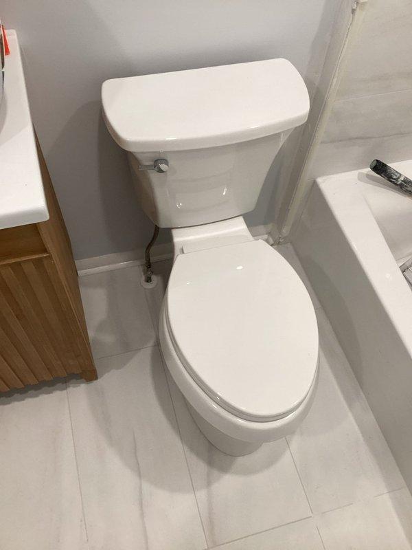 Completed plumbing installation in bathroom, finalizing all fixture connections and ensuring proper operation of toilet water supply lines. Verified all components were securely installed, tested for leaks, and confirmed bathroom was left in clean, functional condition with all fixtures properly positioned and operational.