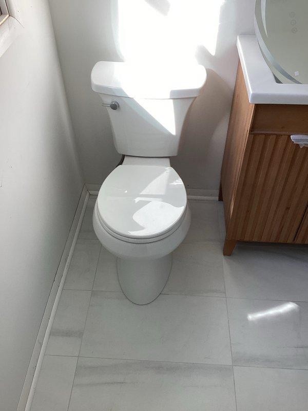Completed plumbing installation in bathroom, finalizing all fixture connections and ensuring proper operation of toilet water supply lines. Verified all components were securely installed, tested for leaks, and confirmed bathroom was left in clean, functional condition with all fixtures properly positioned and operational.