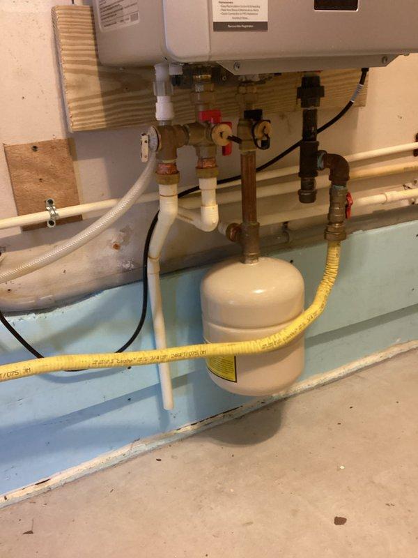 Performed routine maintenance flush on wall-mounted Rinnai tankless water heater system. Descaled unit using manufacturer-approved cleaning solution circulated through the heat exchanger to remove mineral buildup and ensure optimal performance. Inspected all plumbing connections, gas line, expansion tank, and isolation valves for proper operation and confirmed system functionality upon completion.