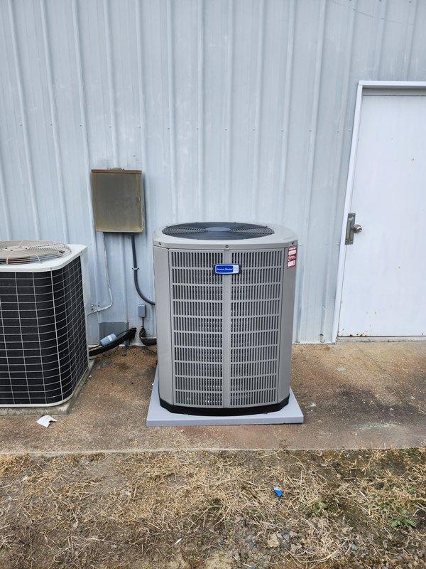 Completed full HVAC system replacement for the right portion of the building, removing and disposing of existing equipment. Installed new heat pump system including 5A6H4060A1000A outdoor unit positioned on pressure-treated wood platform with concrete pad, 5TEM4D07AC51SA air handler with BAYHR1517BRKA 15 KW backup heat kit, and standard heat pump thermostat. Fabricated and installed metal duct transitions to adapt new equipment to existing ductwork, reused existing condensate lines, replaced outdoor disconnect and electrical whip to code. System tested and operational upon completion, with one-year warranty membership including performance tune-up provided to homeowner.