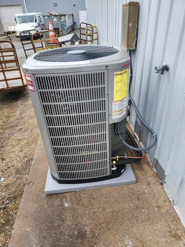 Completed full HVAC system replacement for the right portion of the building, removing and disposing of existing equipment. Installed new heat pump system including 5A6H4060A1000A outdoor unit positioned on pressure-treated wood platform with concrete pad, 5TEM4D07AC51SA air handler with BAYHR1517BRKA 15 KW backup heat kit, and standard heat pump thermostat. Fabricated and installed metal duct transitions to adapt new equipment to existing ductwork, reused existing condensate lines, replaced outdoor disconnect and electrical whip to code. System tested and operational upon completion, with one-year warranty membership including performance tune-up provided to homeowner.