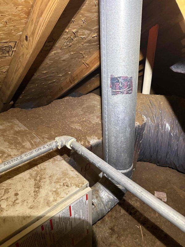Completed comprehensive HVAC system inspection and tune-up service. Accessed attic space to evaluate ductwork system, inspected galvanized metal supply duct and PVC condensate drain line for proper installation and function. Documented water heater condition and verified proper clearances and safety equipment accessibility in mechanical room. All system components found operating within normal parameters with no immediate service concerns identified.