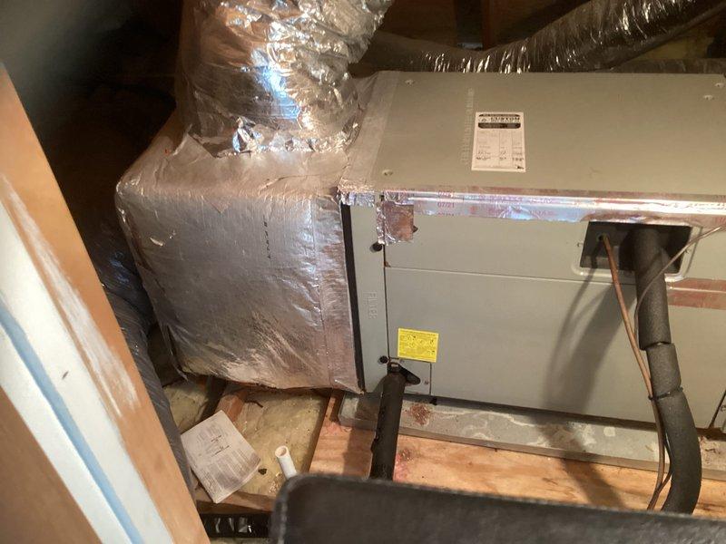Performed on-site assessment of 16-year-old upstairs HVAC system that was not operational. Documented existing air handler unit installed in attic space with connected flexible ductwork and refrigerant lines, and provided comprehensive replacement estimate for complete system changeout.