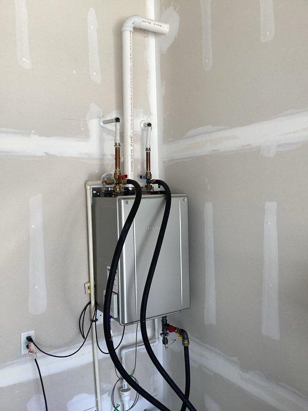 Performed comprehensive inspection and maintenance flush on Navien tankless water heater model Q204. Unit was flushed using descaling solution pumped through the system via service hoses to remove mineral buildup and ensure optimal heat exchanger performance. Verified all plumbing connections, isolation valves, and PVC venting were secure and functioning properly. Confirmed unit operational status and documented installation condition with photos for service records.