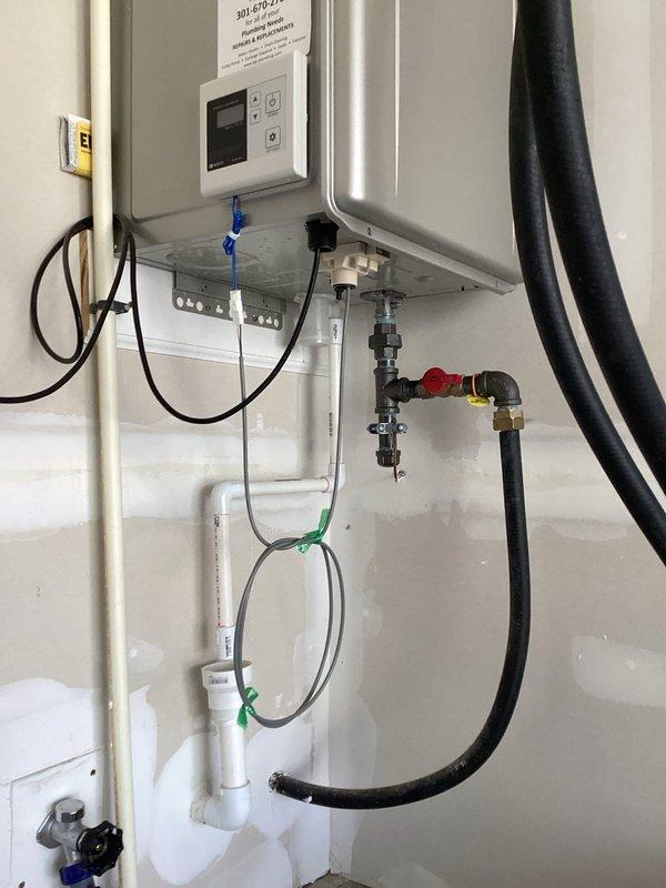 Performed comprehensive inspection and maintenance flush on Navien tankless water heater model Q204. Unit was flushed using descaling solution pumped through the system via service hoses to remove mineral buildup and ensure optimal heat exchanger performance. Verified all plumbing connections, isolation valves, and PVC venting were secure and functioning properly. Confirmed unit operational status and documented installation condition with photos for service records.