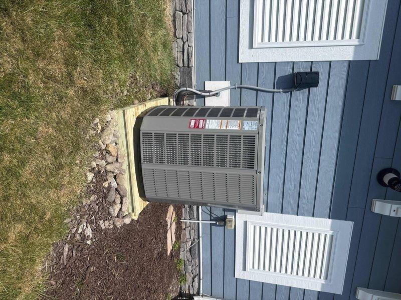 Removed and disposed of existing coil and heat pump system. Installed new 5A6H7048 17 SEER heat pump on pressure-treated wood platform with 5TXCC006 coil in utility room. Fabricated and installed custom transitions to adapt new air handler to existing trunk ductwork. Integrated system with existing damper controls and thermostat setup. Installed new electrical whip and disconnect for outdoor unit. Ran copper refrigerant lines from indoor coil to outdoor heat pump, then flushed, pressure tested, and charged refrigeration system to manufacturer specifications. All equipment operational and performing within normal parameters upon completion.