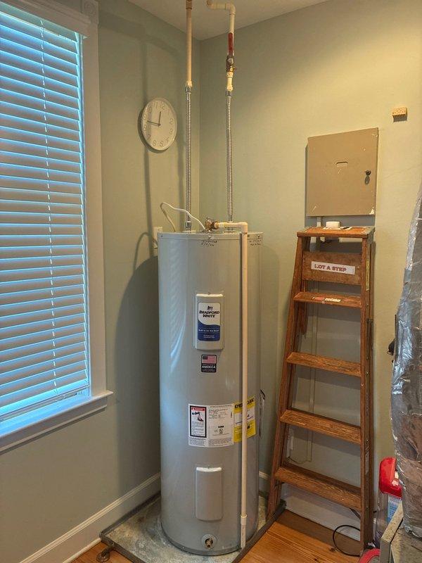 Completed installation of two 50-gallon tall electric water heaters (RE250T6) in residential utility room. Removed existing units and installed new water heaters on 22-inch aluminum drain pans to protect flooring from potential leaks. Connected water supply lines using 18-inch stainless steel flex connectors with 3/4-inch male transition unions for secure, code-compliant connections. Installed expansion tank on cold water supply line using 3/4-inch brass fittings including tee, 90-degree elbow, and nipples of appropriate lengths to properly position tank and accommodate thermal expansion. Verified all electrical connections to 240V power supply were secure and properly terminated. Tested both units for proper operation, checked all plumbing connections for leaks, and confirmed adequate water pressure and temperature settings. Installation required two technicians and approximately four hours to complete. All work performed in accordance with local plumbing codes and manufacturer specif
