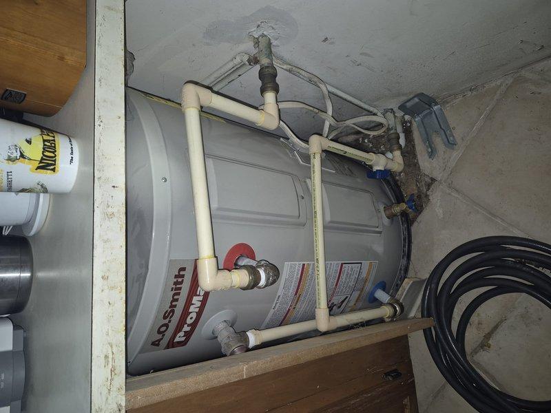 Completed scheduled preventive maintenance inspection on A.O. Smith tanked water heater located in basement utility area. Performed visual assessment of unit condition, verified proper operation of all plumbing connections including inlet/outlet PVC piping and shut-off valves, and inspected mounting platform stability. All components found to be functioning within normal parameters with no leaks or safety concerns identified.