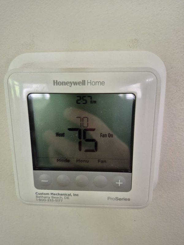 Completed scheduled cooling maintenance visit on residential HVAC system. Verified thermostat operation showing proper temperature control and fan functionality. Performed electrical diagnostics using clamp meter, measuring amperage draw at 97.9A to confirm compressor and system components operating within normal parameters.