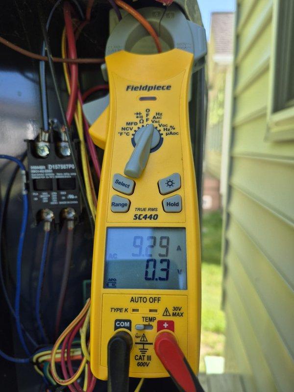 Completed scheduled cooling maintenance visit on residential HVAC system. Verified thermostat operation showing proper temperature control and fan functionality. Performed electrical diagnostics using clamp meter, measuring amperage draw at 97.9A to confirm compressor and system components operating within normal parameters.