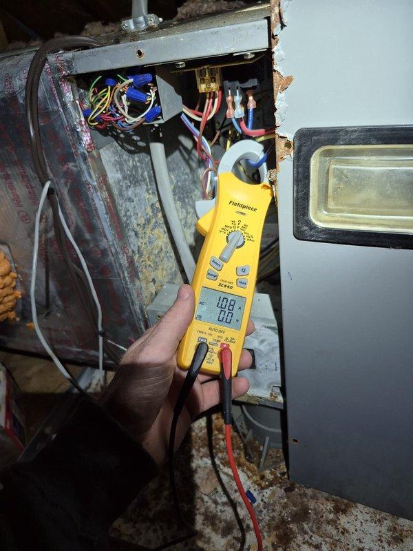 Performed scheduled cooling maintenance visit on HVAC system with significant age-related deterioration. Upon inspection, found extensive rust and corrosion on air handler cabinet and internal components, with accumulated dust and debris throughout the unit. Conducted electrical diagnostics using clamp meter, measuring voltage and amperage at capacitor and wire connections. Verified proper electrical connections at fuse block and terminal connections, noting multiple wire bundles secured with proper strain relief. All electrical components tested within operational parameters despite visible wear on equipment housing. System operational at time of departure, though equipment shows advanced aging with surface oxidation on metal panels and cabinet framework.