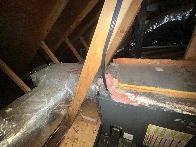 Completed preventive maintenance cooling visit on two HVAC systems located in attic space. Accessed equipment via pull-down attic ladder, performed standard inspection and maintenance procedures on both air handlers including filter checks, coil inspection, and system operational verification. Both units showed normal dust accumulation consistent with regular operation, all ductwork and insulation intact and properly secured.