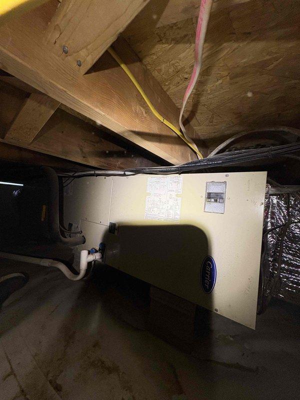 Completed cooling system inspection and tune-up on Carrier air handler unit located in crawl space. Performed comprehensive system evaluation including inspection of ductwork, electrical connections, condensate drainage lines, and unit operation per maintenance contract requirements. All components found to be functioning within normal parameters, with photos documented for service records.