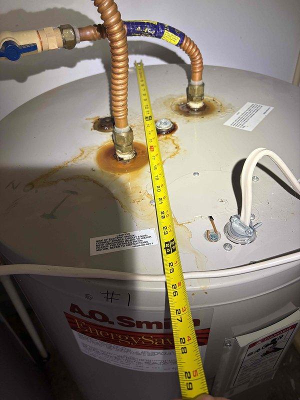 Completed cooling system inspection and tune-up as part of annual maintenance contract. Documented existing water heater with significant rust corrosion around top pipe connections and fittings, indicating potential age-related deterioration. Inspected electrical panel and verified all circuit breakers operational with proper labeling in place.