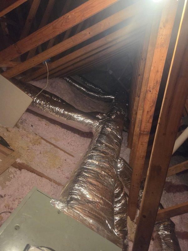 Removed and replaced animal-damaged ductwork in attic space with new insulated metal duct trunk lines and flexible branch runs equipped with balancing dampers. Existing HVAC equipment, metal boots, and registers were retained and reconnected to the new duct system. Installation completed per specifications with proper insulation and support throughout the attic space.