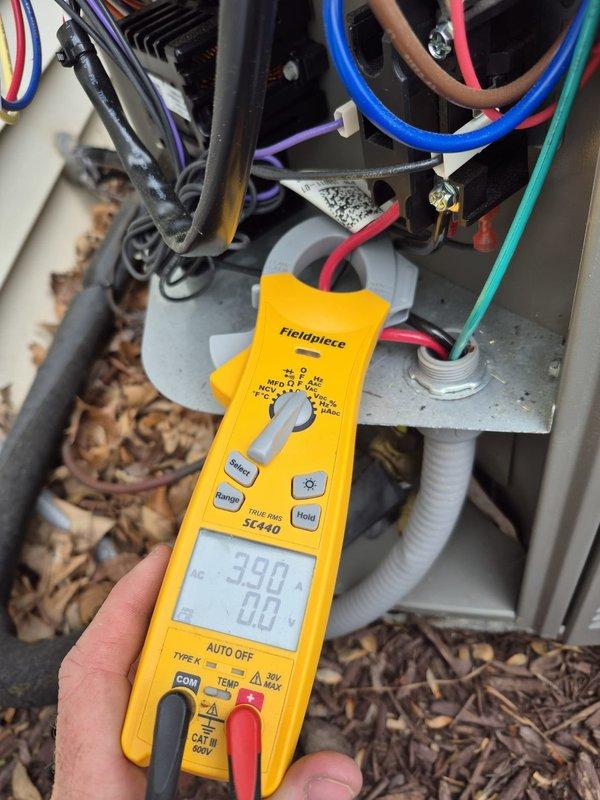 Completed routine cooling maintenance visit on HVAC system. Performed electrical diagnostics using clamp meter to verify amperage readings on outdoor unit components, confirmed proper operation of compressor and condenser fan motor. Verified thermostat functionality with Honeywell ProSeries unit displaying 74°F ambient temperature in cooling mode with auto fan setting, system maintaining setpoint accurately at time of service.