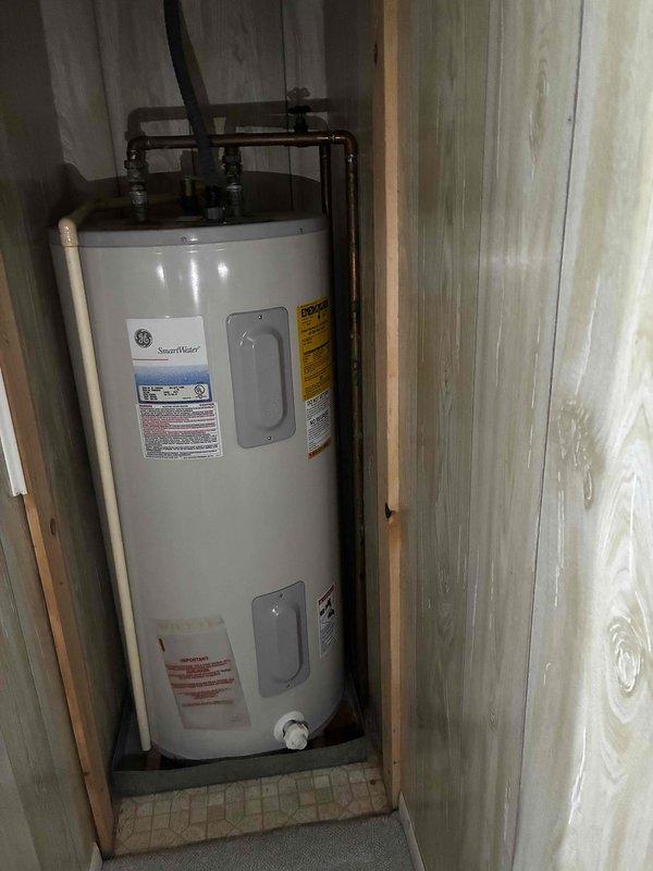 Provided estimate for replacement of existing 50-gallon GE SmartWater electric water heater with new 4500-watt unit measuring approximately 4 feet tall. Assessed installation location within confined wooden utility closet with 24-inch access doorway and confirmed dimensions of existing 22-inch wide by 48-inch tall water heater to ensure proper replacement unit sizing and clearance requirements for removal and installation.