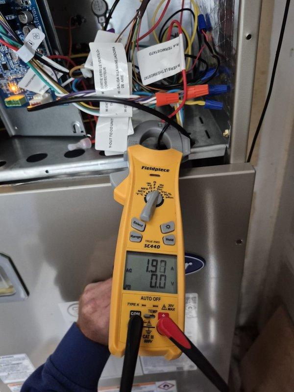 Completed preventative maintenance cooling visit on first of two HVAC systems. Performed electrical diagnostics using digital multimeter, verifying voltage readings at control board and confirming proper operation of relay switches and wiring connections within the electrical cabinet. Checked thermostat functionality, confirmed unit responding correctly to temperature settings with system currently in permanent hold mode at 68°F with heating/cooling system in OFF position.