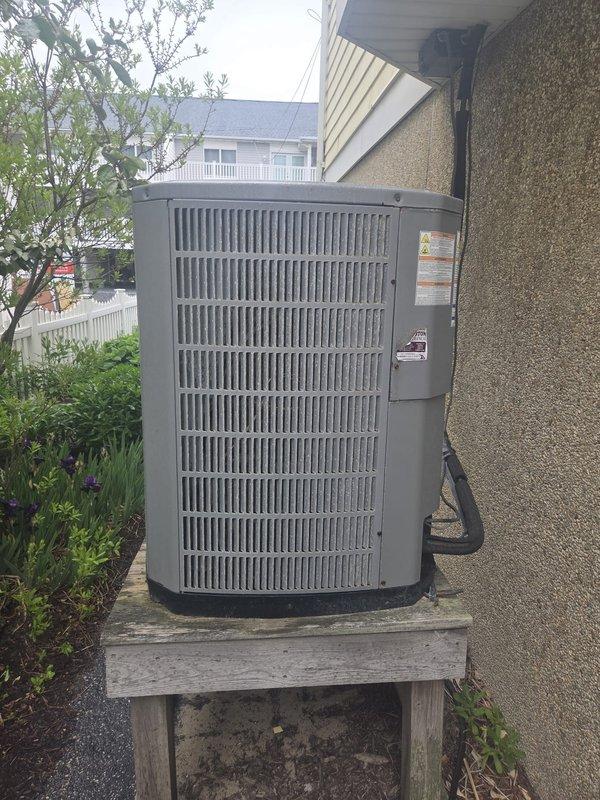 Completed scheduled cooling maintenance visit on residential HVAC system. Inspected outdoor condenser unit mounted on wooden platform, verified proper operation and clearances, and documented water heater and expansion tank configuration in mechanical closet with associated plumbing connections. All cooling system components found operating within normal parameters.