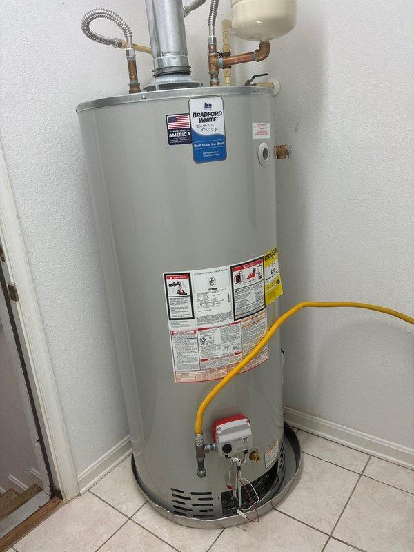 Completed installation of 75-gallon Bradford White gas water heater model RG275H6X1. Installed 28-inch drain pan beneath unit for leak protection and mounted thermal expansion tank to accommodate system pressure fluctuations. Connected hot and cold water supply lines using 18-inch flexible stainless steel connectors with 3/4-inch brass fittings, including brass nipples, 90-degree elbow, and tee connections as required for proper water flow configuration. Installed temperature and pressure relief valve with appropriate discharge piping. Connected gas supply line to burner assembly and verified all connections for proper operation. Configured galvanized steel venting system with multiple elbows to ensure proper exhaust ventilation. Tested all water connections for leaks, verified gas connections for safety, and confirmed unit functionality. Shut off water supply per owner's request upon completion of installation.