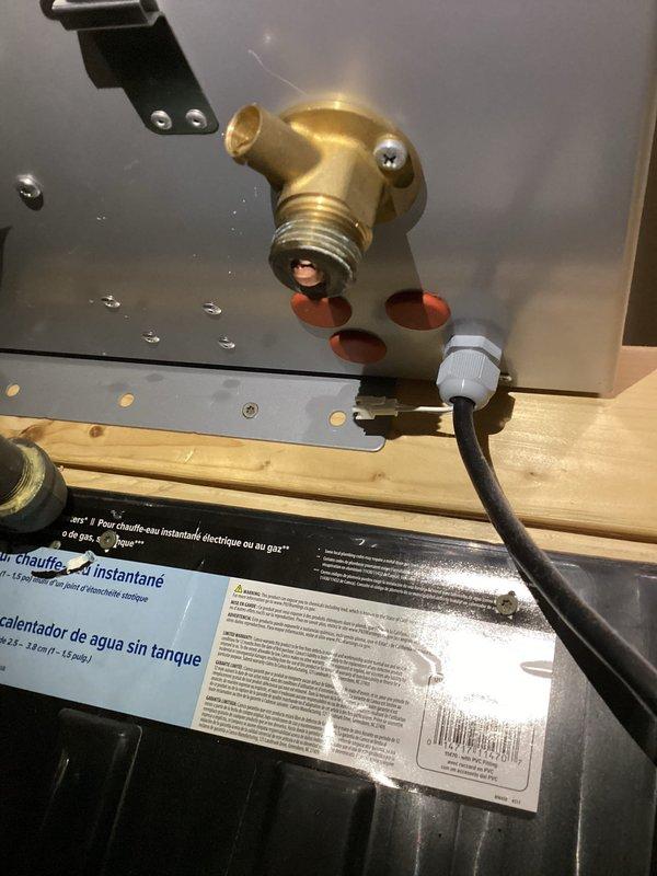 Responded to service call for leaking valve on outside shower foot wash attachment. Diagnosed faulty valve cartridge causing water leak at connection point. Removed defective valve assembly from brass elbow fitting and replaced with new valve cartridge. Tested system for proper operation and verified leak was eliminated. Installation secured and system returned to normal function.