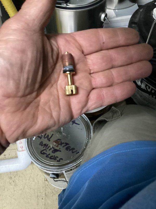 Responded to service call for leaking valve on outside shower foot wash attachment. Diagnosed faulty valve cartridge causing water leak at connection point. Removed defective valve assembly from brass elbow fitting and replaced with new valve cartridge. Tested system for proper operation and verified leak was eliminated. Installation secured and system returned to normal function.