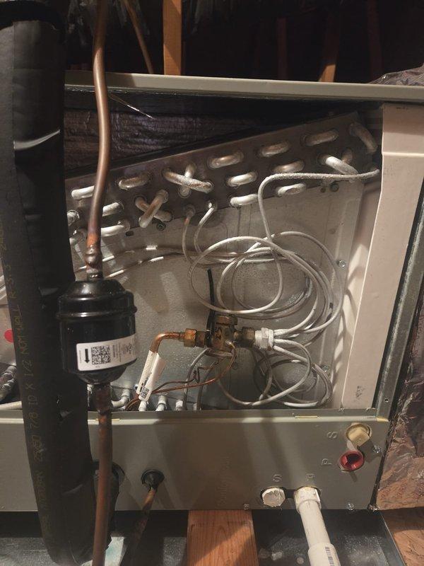 Completed scheduled cooling maintenance visit on HVAC system currently set to heating mode. Switched system from heat to cooling operation per customer request and adjusted thermostat settings accordingly. Performed standard cooling system inspection including visual examination of evaporator coil, blower motor assembly, capacitor connections, refrigerant lines, and electrical components. All wiring connections secure, coil condition acceptable, and unit operational. Documented equipment condition with photos showing motor/capacitor assembly and evaporator coil configuration within air handler unit located in attic space.