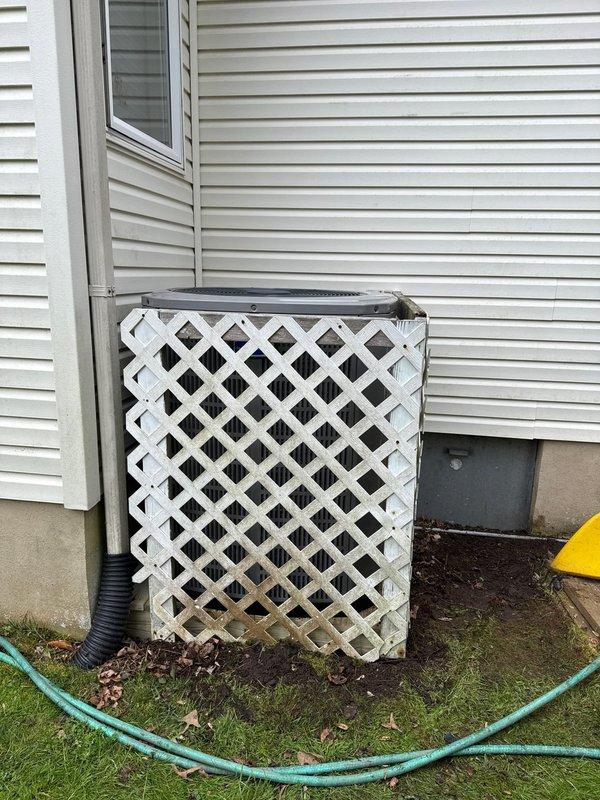 Completed full removal and replacement of dual HVAC systems at residential property. Removed and properly disposed of existing equipment from both zones. Installed 4-ton 14 SEER heat pump model 5A6H4048 with variable speed fan coil unit model 5TEM6D05, equipped with 15KW backup heater and breaker. Installed 2.5-ton 14 SEER heat pump model 5A6H4030 with variable speed fan coil unit model 5TEM6B02, equipped with 10KW backup heater and breaker. Mounted outdoor units on elevated platforms for proper drainage and airflow. Fan coil units installed in drain pans with integrated shut-off valves for maintenance accessibility. Installed electrical whips and disconnect boxes at each outdoor unit location per code requirements. Flushed existing refrigeration lines, performed pressure testing to verify system integrity, and recharged to manufacturer specifications. Installed 1-inch filter racks on both systems for improved filtration. Mounted Honeywell T-6 non-programmable thermostats with wall pla