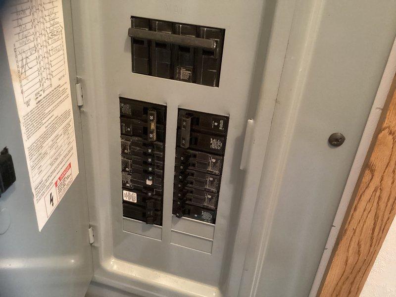 Provided estimate for complete dual fuel heat pump system replacement after diagnosing failed compressor in existing outdoor unit. Assessed current installation including aged condenser unit mounted on weathered wooden platform with drainage pan, reviewed electrical panel configuration, and documented system specifications to prepare comprehensive replacement proposal for customer consideration.