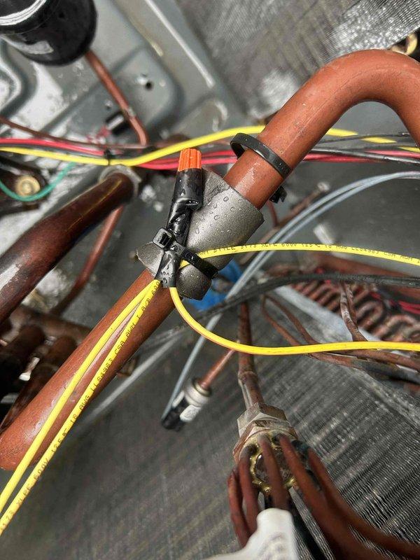 Responded to no cooling call on 10+ year old HVAC system. Upon inspection, found unit inoperative with visible moisture on copper refrigerant lines and aged components showing oxidation and wear. Performed diagnostic evaluation of electrical connections, refrigerant piping, and blower assembly to identify failure points. Documented system condition with photos showing copper tubing, wiring harness, heat exchanger coils, and internal mechanical components for service records and potential system replacement discussion.