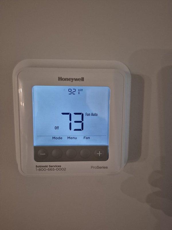 Performed routine cooling maintenance visit on residential HVAC system. Verified thermostat operation showing system in off mode with proper display functionality. Conducted electrical diagnostics on outdoor condensing unit using clamp meter to measure amperage and confirm proper electrical performance of compressor and fan motor circuits.