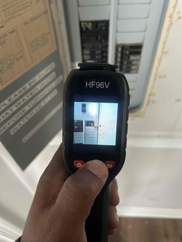 Responded to service call for lower floor HVAC unit not responding on mobile application. Performed diagnostic inspection using thermal imaging camera to scan electrical panel and circuit breakers, identifying no abnormal heat signatures or electrical issues. Measured supply duct temperatures with infrared thermometer to verify system operation. Determined unit was functioning properly with no mechanical or electrical faults; connectivity issue was related to WiFi/network configuration rather than HVAC equipment malfunction.