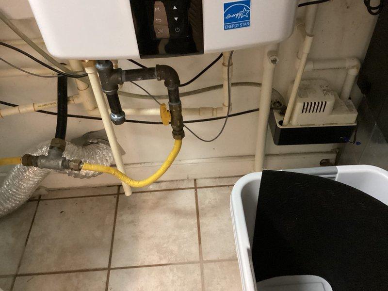 Completed installation of two Navien tankless water heaters in a side-by-side configuration in the utility room. Units were wall-mounted and connected with white PVC venting systems running horizontally between both heaters with proper elbow joints and vertical exhaust terminations. Yellow CSST gas lines were installed and secured with appropriate supports to supply both units, with all gas connections properly made and tested. Water supply piping was completed using a combination of PEX and copper connections, including isolation valves for service access. Electrical wiring was run and terminated at both units to provide power to the digital control panels. All manufacturer specifications were followed for proper clearances, venting requirements, and installation guidelines. System was pressure tested, fired up, and verified for proper operation on both units.