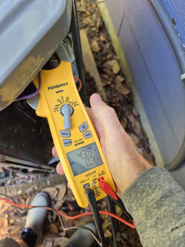 Completed scheduled maintenance on two heating systems. Performed comprehensive system diagnostics and operational testing using digital multimeter to verify electrical parameters and system performance. Both units showed readings within normal operating ranges. Inspected condensing unit and identified significant accumulation of organic debris, leaves, and dirt around compressor housing and internal components. Cleaned debris from unit interior to restore proper airflow and prevent potential operational issues. Verified all electrical connections secure and functioning properly. Both systems operating normally upon completion of maintenance service.