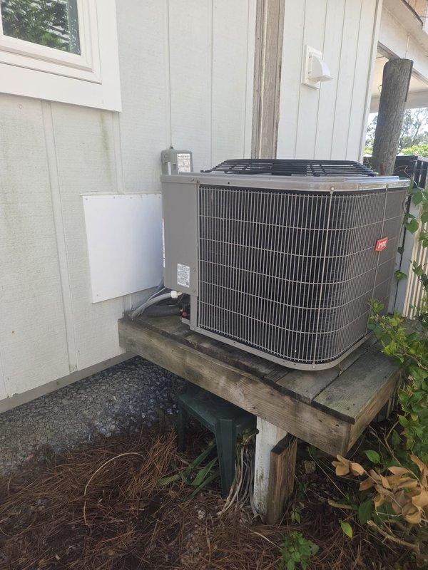 Relocated refrigeration lines to accommodate interior renovation work requiring removal of existing lines from wall cavity. Pumped refrigerant charge into condenser unit, disconnected and removed old line set from interior walls, then installed new refrigeration lines routed down exterior wall and across to outdoor condenser unit. Covered exposed exterior line set with PVC slim duct for protection and aesthetics. Pulled full micron vacuum on system to verify integrity of new line set, then recharged system to manufacturer specifications and verified proper operation with digital multimeter readings.