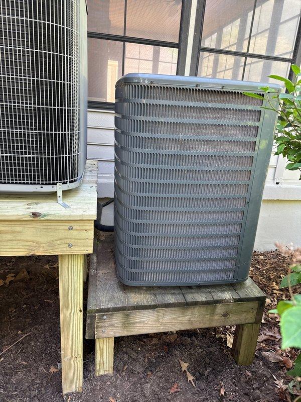 Completed full HVAC system replacement including removal and disposal of existing equipment. Installed Carrier 27SCA524A003 2-ton 15 SEER heat pump outdoor unit on treated wooden stand positioned over existing platform, Carrier FT5ANXB24L00 variable speed air handler, Carrier FF2601C10 10kW electric heat kit, and Honeywell WiFi thermostat. Fabricated and installed metal duct transitions to adapt new equipment to existing ductwork. Replaced outdoor electrical disconnect and electrical whip with new components. Reused existing electrical service, condensate drain lines, and power connections where applicable. Performed system startup, refrigerant charge verification, and operational testing using diagnostic equipment to confirm proper system performance across all operating modes. All equipment installed per manufacturer specifications and local code requirements. System operational and one-year maintenance agreement initiated for two-system residence.