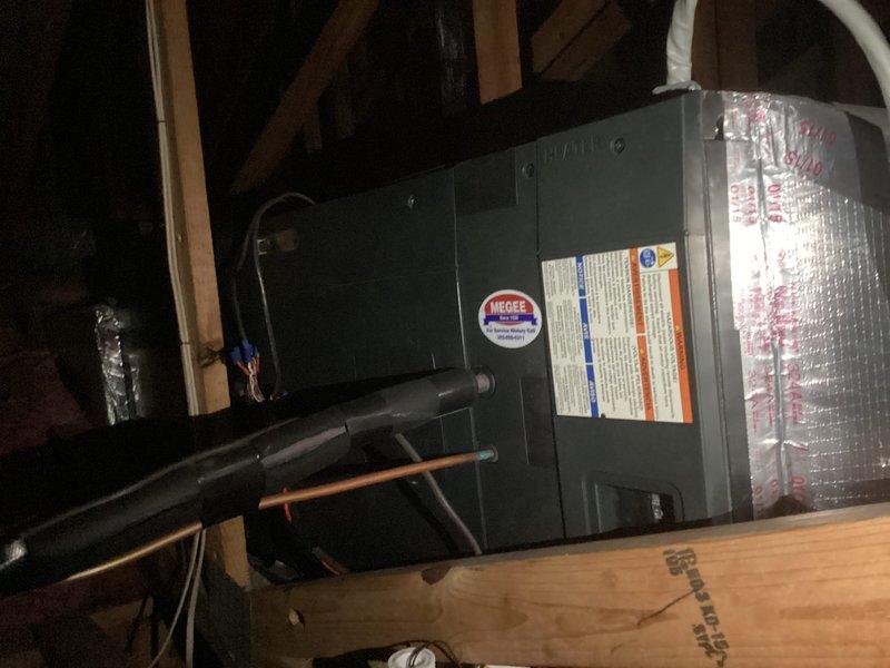 Completed estimate for replacement of existing Trane HVAC system located in master bedroom closet attic space. Assessed horizontal furnace unit with existing refrigerant lines and ductwork configuration in confined attic area with exposed framing. Documented equipment specifications and access requirements, noting 6-8" ladder needed for future installation access to unit positioned in closet ceiling space.