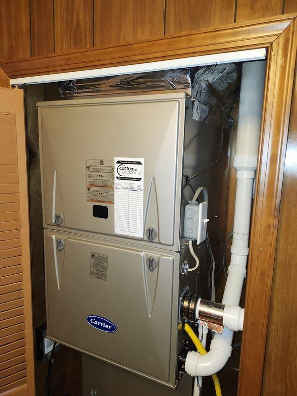 Completed full HVAC system replacement including removal and disposal of existing equipment. Installed new Carrier 59SC2E100M21 92% AFUE gas furnace with LP conversion kit, Carrier 26SCA560W003 5-ton 15 SEER air conditioning condenser, and Carrier CAAMP6121AMA evaporator coil. Fabricated and installed metal duct transitions to adapt new equipment to existing ductwork. Reused existing condensate drain lines while replacing outdoor electrical disconnect and electrical whip for code compliance. Constructed pressure-treated wood platform and positioned outdoor condenser unit with proper clearances. Installed Honeywell digital WiFi thermostat for system control. Tested all system functions including heating and cooling cycles, verified proper refrigerant charge, confirmed adequate airflow, and ensured all electrical connections meet manufacturer specifications.