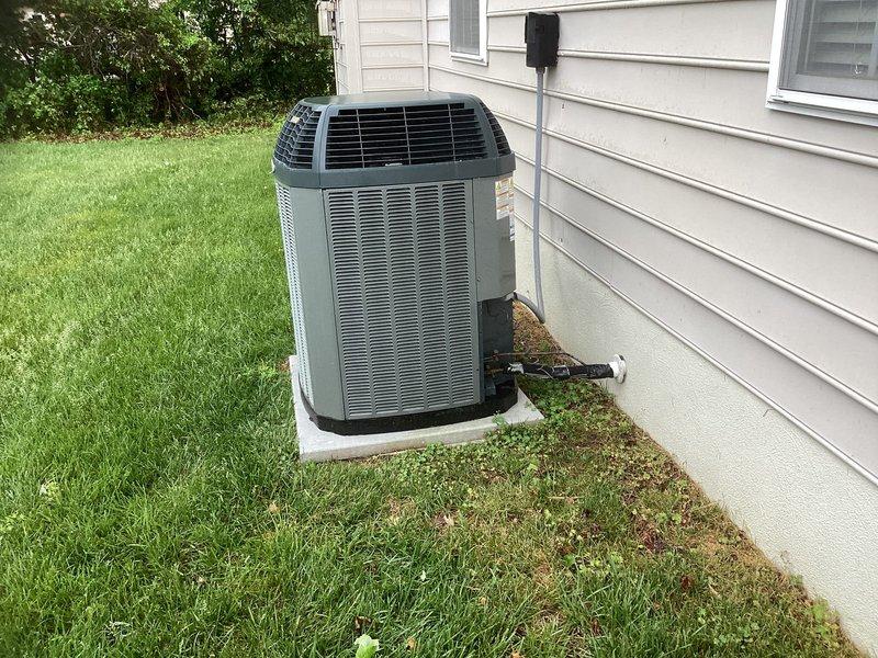 Conducted estimate for replacement of 12-year-old Trane HVAC system with equipment located in attic requiring ladder access. Evaluated existing outdoor condenser unit on concrete pad and documented attic access point through ceiling hatch for complete system replacement assessment.