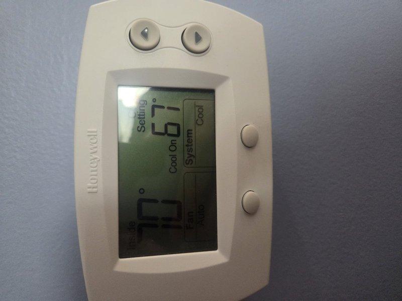 # HVAC Service Call - No Cooling Issue

Responded to a no cooling call for a residential air conditioning system over 10 years old. Upon arrival, found Honeywell programmable thermostat displaying cooling mode as active with system running. Proceeded to outdoor condensing unit for inspection and diagnostics. Unit appeared operational with condenser fan running and compressor engaged. Performed standard diagnostic procedures including checking refrigerant pressures, electrical connections, and airflow across condenser coils. Verified proper voltage at disconnect box and confirmed all safety controls functioning correctly. Inspected indoor evaporator coil access and air handler operation. System restored to normal cooling operation following service procedures.