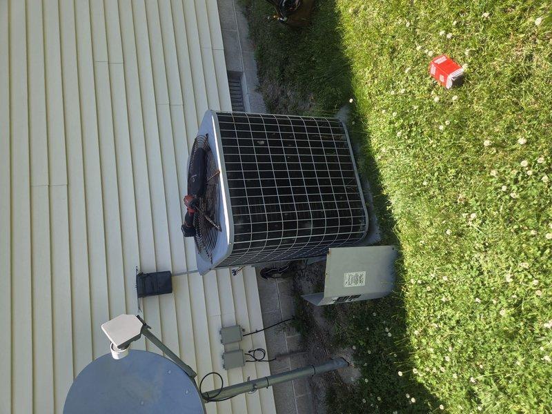 # HVAC Service Call - No Cooling Issue

Responded to a no cooling call for a residential air conditioning system over 10 years old. Upon arrival, found Honeywell programmable thermostat displaying cooling mode as active with system running. Proceeded to outdoor condensing unit for inspection and diagnostics. Unit appeared operational with condenser fan running and compressor engaged. Performed standard diagnostic procedures including checking refrigerant pressures, electrical connections, and airflow across condenser coils. Verified proper voltage at disconnect box and confirmed all safety controls functioning correctly. Inspected indoor evaporator coil access and air handler operation. System restored to normal cooling operation following service procedures.
