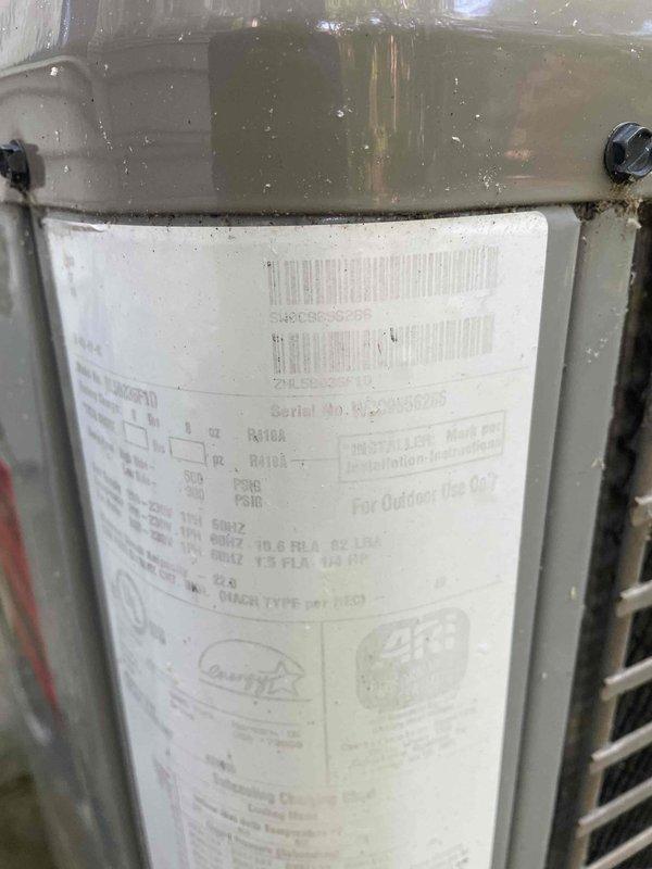 Performed seasonal cooling system maintenance check on outdoor condensing unit and indoor air handling equipment. Inspected R410A outdoor unit showing normal weathering, verified nameplate specifications and serial number documentation, and examined attic-mounted HVAC components including supply ductwork and insulated flex runs for proper installation and condition.