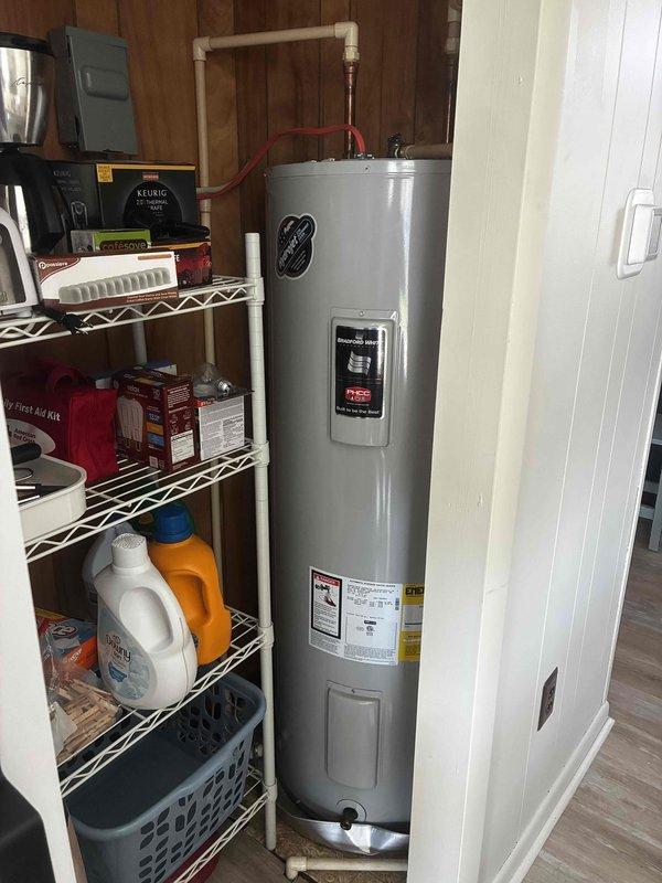 Responded to service call for electric water heater experiencing intermittent power loss requiring frequent manual reset of high-temperature limit switch. Upon inspection, determined water heater unit was not receiving consistent electrical power. Traced electrical supply and identified issue with utility company load management control box interrupting power delivery to the water heater. Verified water heater specifications showing 22-inch width unit installed in 26-inch available space. Documented installation with measurements and photographs. Contacted property owner to report findings and recommended coordination with electric utility provider to service or replace faulty load management box before proceeding with further water heater diagnostics or repairs.