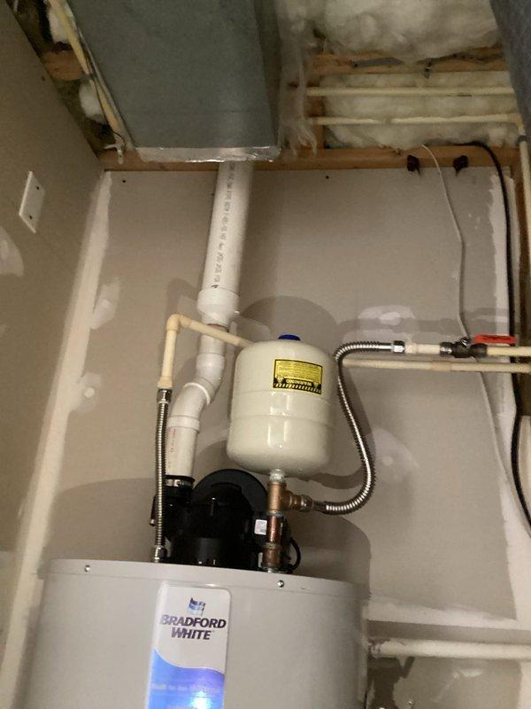 Installed a 50-gallon Bradford White power vent water heater (model RG1PV50S6X1) in the utility area. Installation included a 24-inch drain pan, thermal expansion tank, brass fittings (3/4" x 2" nipple, 3/4" x 6" nipple, 3/4" tee, and 3/4" 90-degree elbow), and two 18-inch flexible water connectors. Connected gas supply line, water supply lines, and venting system, ensuring all components meet code requirements and manufacturer specifications.