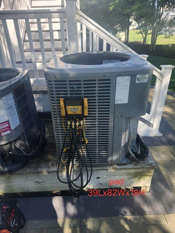 Responded to no cooling complaint on residential split system. Upon arrival, connected manifold gauges to outdoor condensing unit and performed system diagnostics. Unit was not maintaining set temperature as reported. Completed refrigerant pressure testing and system evaluation to identify cause of inadequate cooling performance. Documented equipment condition with photos showing dual condensing units installed on exterior deck platform with testing equipment connected during diagnostic process.